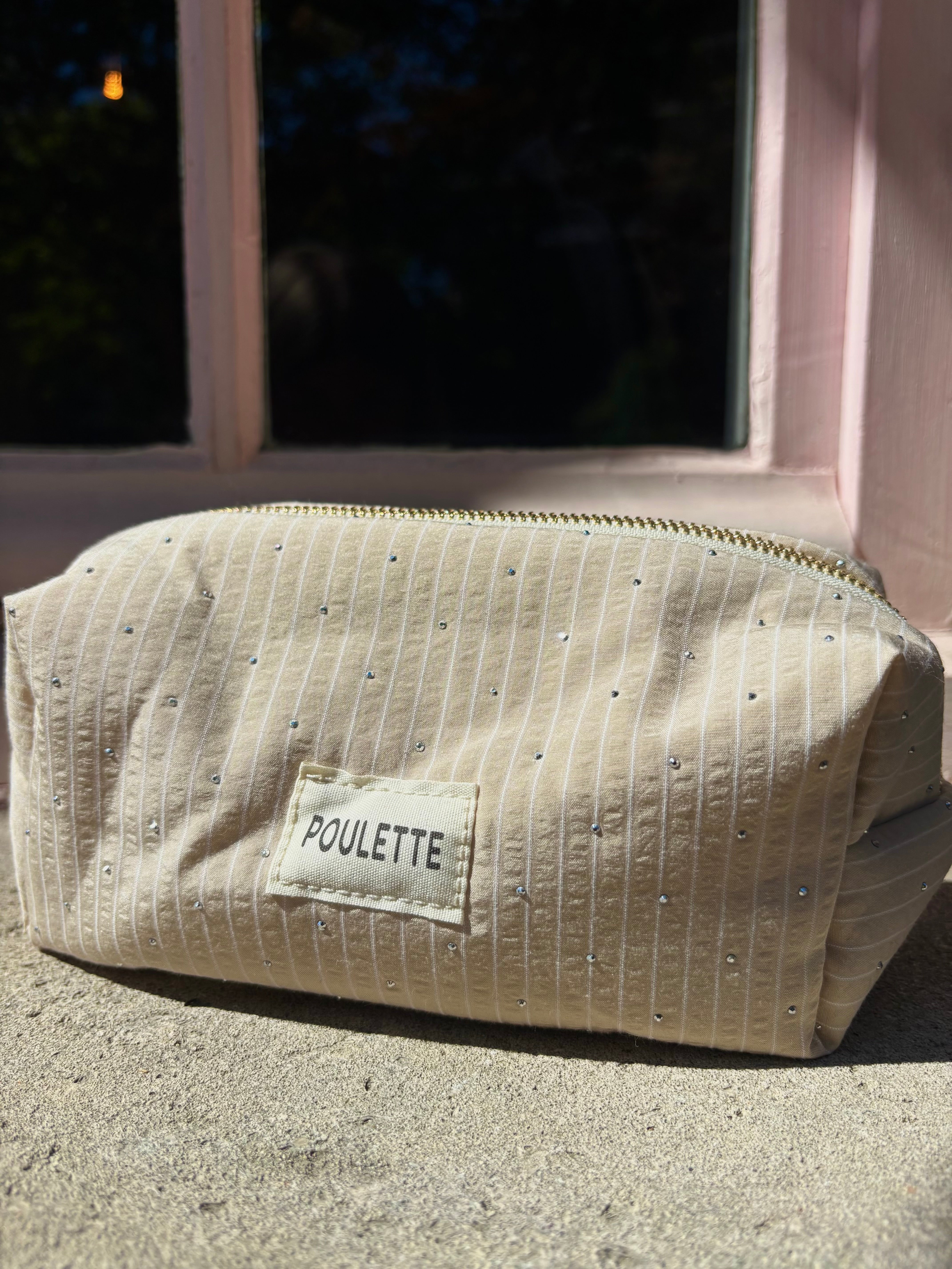 Trousse de toilette beige à rayures et stras